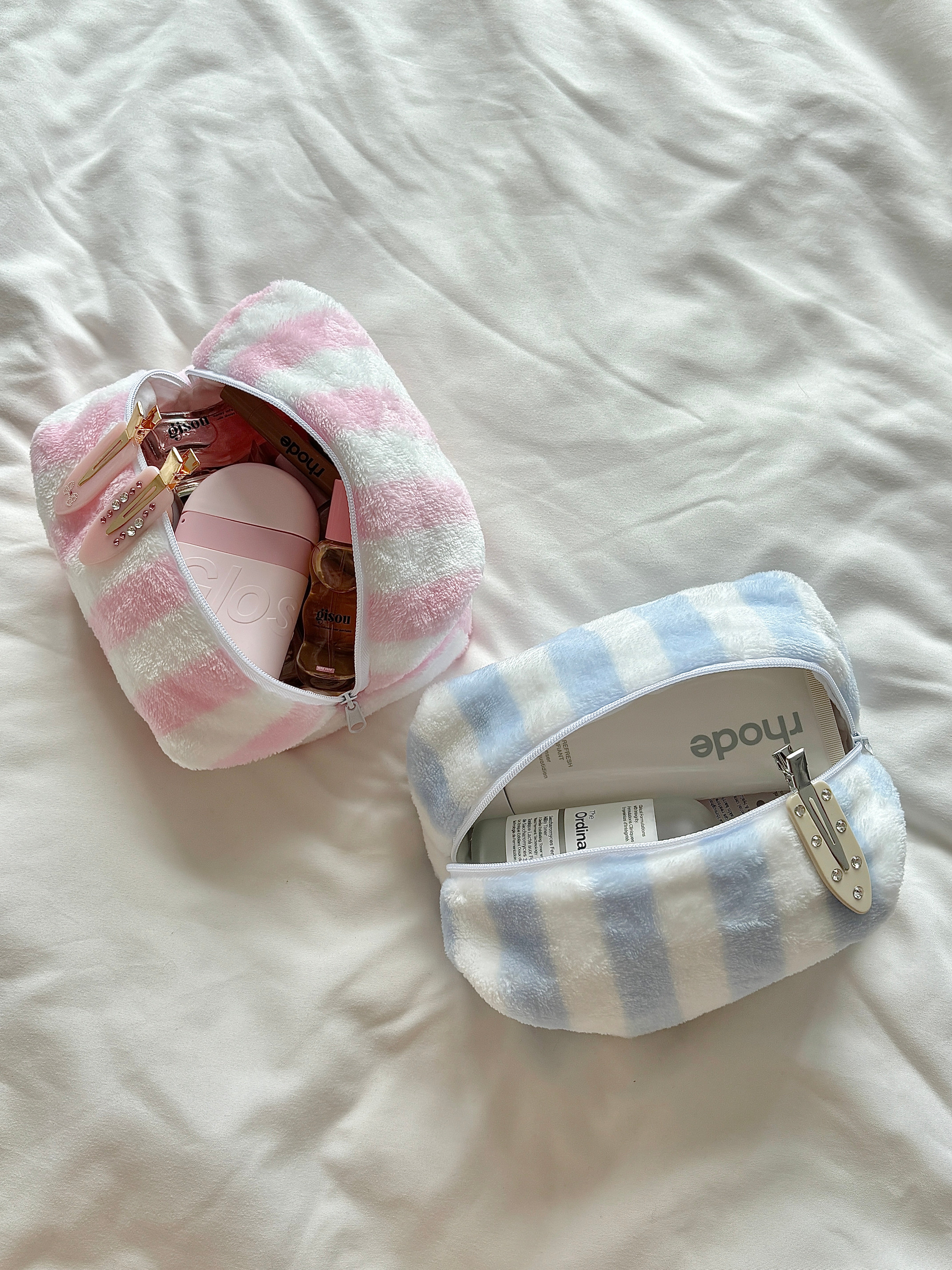 Pink and blue striped makeup pouch with fluffy flannel texture, girly aesthetics